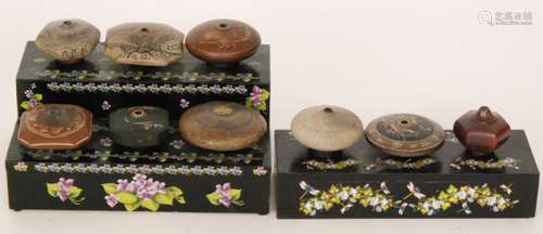 A collection of nine Chinese terracotta and pottery pipe bowls decorated with landscapes and fauna, some signed, on later stands (9)