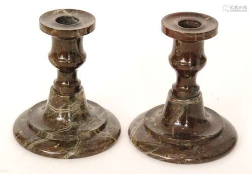 A pair of 19th Century Serpentine candlesticks, the swept stepped foot below a waisted stem and sconce, height 13cm. (2)