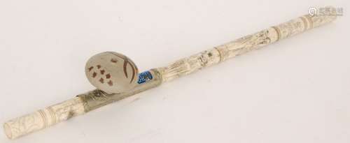 A Chinese bone opium pipe decorated with panels of immortals within ribbed bands, plated saddle with blue enamelled mounted character mark and painted grey pottery bowl, length 51cm