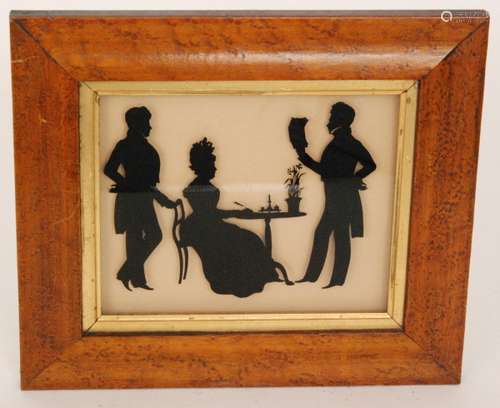 A 19th century maple framed reverse glass painted silhouette of a gentleman dressed in Georgian style reading a letter to a lady and companion, 16cm x 19cm, framed.