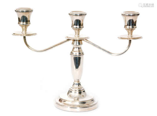 A modern hallmarked silver two branch candelabra, urn shaped sconces above central column and circular filled base, height 23cm, Birmingham 1981