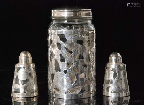 A Mexican silver overlay cylindrical jar with screw top cover, two matching peppers, stamped made in Mexico with makers mark LHM, and a Mexican Sterling silver shell form butter dish (4)