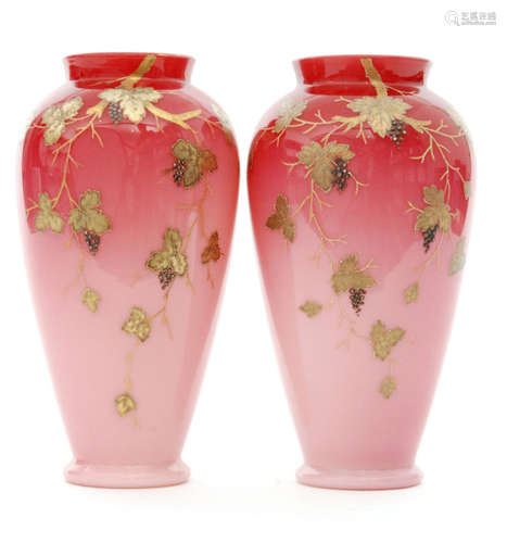 A pair of late 19th Century Harrach Peachblow vases of footed, shouldered ovoid form with collar necks, cased in a graduated ruby over opal and relief paste gilt decorated with fruiting vine boughs, enamelled propeller mark, height 18cm. (2)