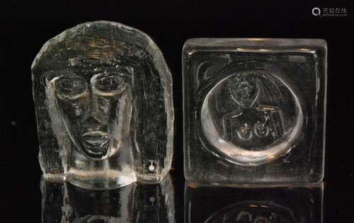 A post war Boda clear crystal glass dish designed by Erik Hoglund, of square from with a central moulded primitive figure, engraved signature diameter 10cm, together with a similar style Pukeberg piece depicting a primitive face, height 12cm. (2)