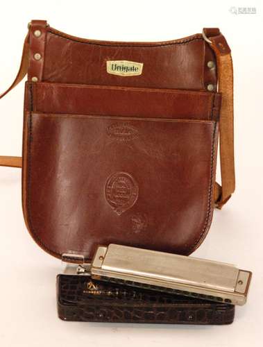 An M.Hohner '64 Chromonica' harmonica in simulated crocodile skin case, together with a Unigate milkman's leather collection satchel, stamped Peter Jones, Abergavenny (2)