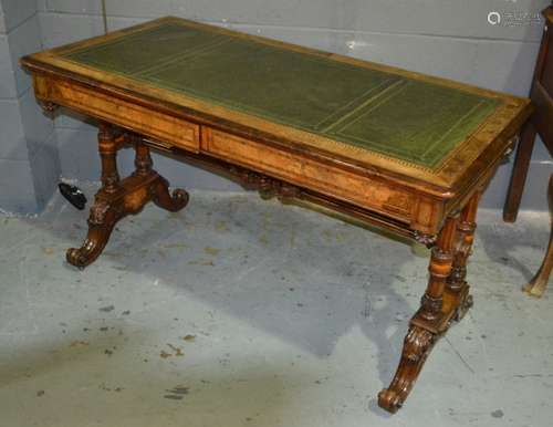 A Victorian inlaid figured walnut two drawer library table with green leather inset top above two drawers on twin fluted end supports and scroll feet, width 130cm