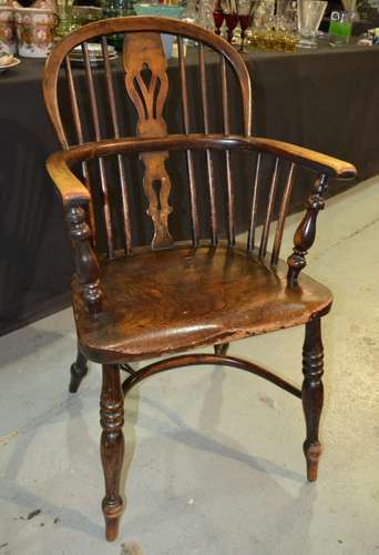 A 19th Century ash and elm seat Windsor elbow chair with pierced splat above a Crinoline stretcher and splayed legs.