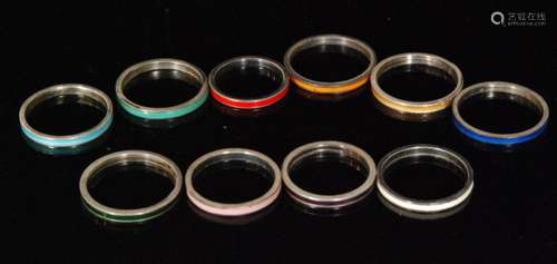 Ten assorted silver rings each with a different colour enamel decoration, various sizes, all Bernard Instone. (10).