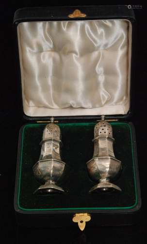 A cased set of hallmarked silver pepper pots, each of octagonal baluster form with pierced pull off cover, Birmingham 1898, J R Ltd