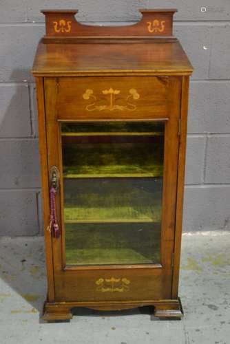 An Art Nouveau inlaid mahogany music cabinet with four plush lined adjustable shelves enclosed by a glazed door on bracket feet, width 48cm