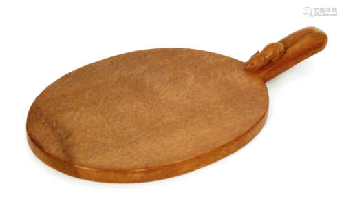 A Robert 'Mouseman' Thompson oak cheeseboard of ovoid form, with carved 'mouse' signature to the handle, width 38cm