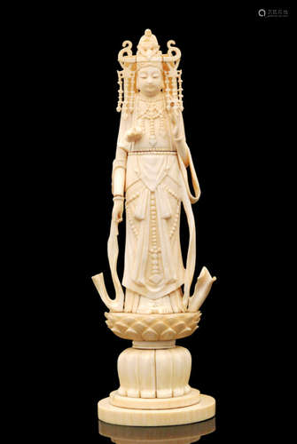 A Japanese Meiji period sectional ivory okimono depicting Guanyin or Kwannon, Goddess of Mercy, dressed in flowing robes with headdress surmounted by a Buddha, lotus flower adornment and standing on a lotus flower pedestal  base, height 30cm, red seal mark to base, S/D