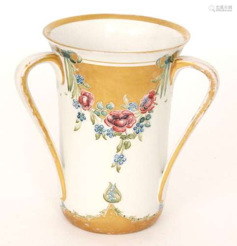 An early 20th Century William Moorcroft for James Macintyre & Co three handled vase decorated in the 18th Century pattern with swags of roses and forget-me-nots held with ribbons, printed mark and signed in green, height 19.5cm, S/D