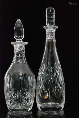 A post war Webb Corbett clear crystal glass decanter of slender form below a pillar form stopper decorated with wide hobnail cutting, together with a similar smaller example with a band of printie cuts, acid marked, tallest 33cm. (2)