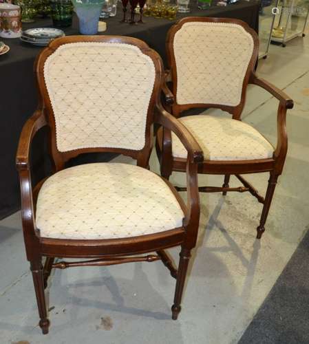 A pair of 20th Century walnut elbow chairs, the shaped backs above turned fluted legs to the front upholstered in cream hatch design (2)