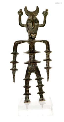 A Benin style bronze horned figure with anklets to arms and legs mounted on a perspex base, height 22cm