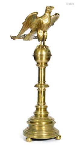 An Edwardian brass eagle floorstanding lectern, by Jones & Willis, the bird perched on a sphere above a Doric column and circular base on ball feet, bears inscription to commemorate the coronation of King Edward VII and Queen Alexandra presented by the congregation of St John's parish Stourbridge June 26th 1902, height 178cm  Jones & Willis were makers of church furniture and medieval metal work manufacturers