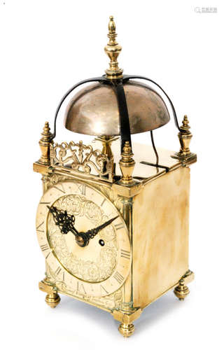 A late 17th to early 18th Century brass lantern clock with converted key wind barrel movement below a bell mounted with a brass finial above a floral dial and chapter ring inscribed Thomas Hanni Londonn (sic), height 39cm