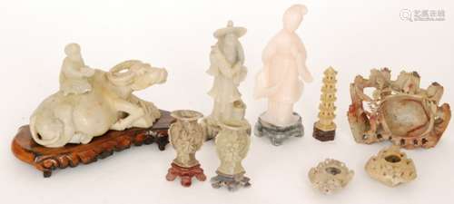 A group of nine Chinese soapstone carvings to include a geisha girl standing on a mottled grey plinth, a recumbent water buffalo with seated figure on its back, a fisherman, a pair of brush washer pots and vases etc. (9)