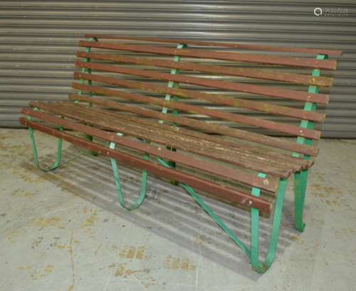 A pair of green painted shaped wrought iron framed wooden slatted garden benches, length 179cm (2)