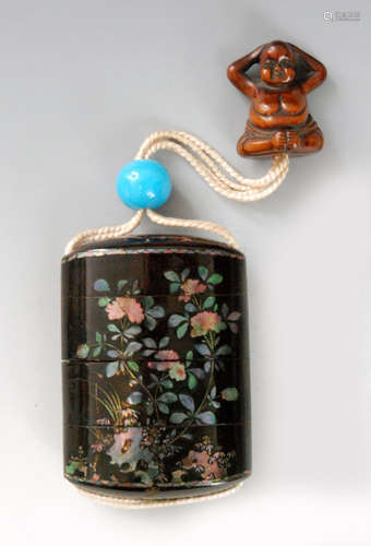 A late 19th Century Somada type three case inro the roiro ground inlaid with aogai (mother of pearl) peonies growing from rock work, length 7.3cm, with a sky blue ojime bead and a boxwood netsuke of a seated woman stripped to the waist adjusting her hair, height 3.5cm.   BR 077/27