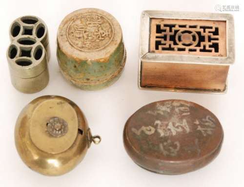 A Chinese oval brass opium box and cover decorated with a lotus flower, a small copper box with character mark to lid, a green glazed pottery opium box with character mark to base, a small brass example and a rectangular box with sliding cover (5)