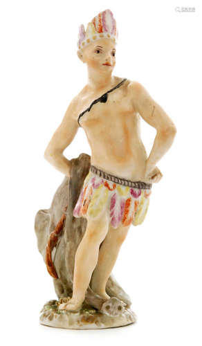 A 19th Century figure modelled as a boy dressed as an American Indian with a brightly coloured feathered skirt and headpiece holding an elephant skin behind his back, unmarked, possibly Derby, height 16.5cm