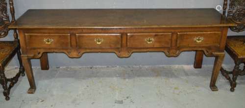 An 18th Century style oak dresser fitted with four short drawers below a moulded edge top, brass fret drop handles on cabriole legs terminating in hoof feet, length 213cm