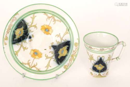 A William Moorcroft for Macintyre & Co breakfast tea cup and saucer decorated with yellow poppies and foliage against blue cartouche panels and a white ground, printed mark, saucer diameter 17.5cm, S/D