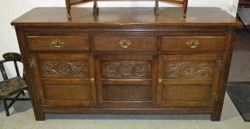 An 18th Century style carved oak sideboard fitted with three drawers with one drawer containing a canteen of plated Kings pattern cutlery for eight place settings, panelled carved front on block feet, length 155cm