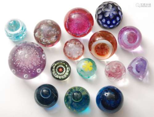 A large assorted collection of 20th Century glass paperweights to include Mdina, Langham and Caithness examples. (Qty)