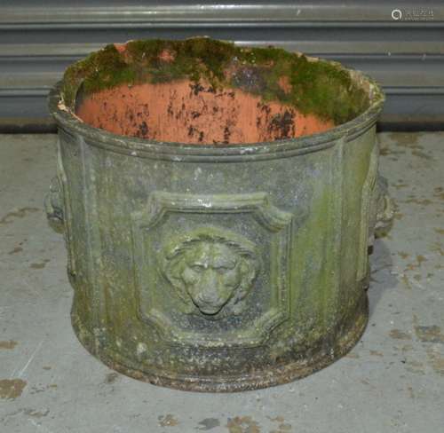 A circular lead planter with lion mask design within cartouche borders, 40cm diameter