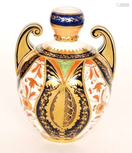 A late 19th Century Royal Crown Derby twin handled vase decorated in an Imari pattern with gilt detailing and banding, red printed mark with date code for 1884, height 18cm