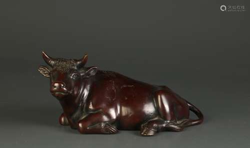 A Japanese or Chinese Bronze Seating Bull, Signed