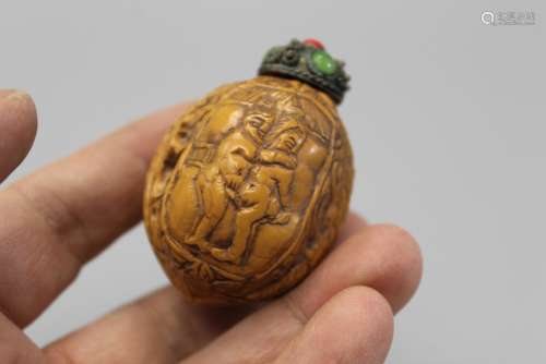 Chinese carved walnut snuff bottle.