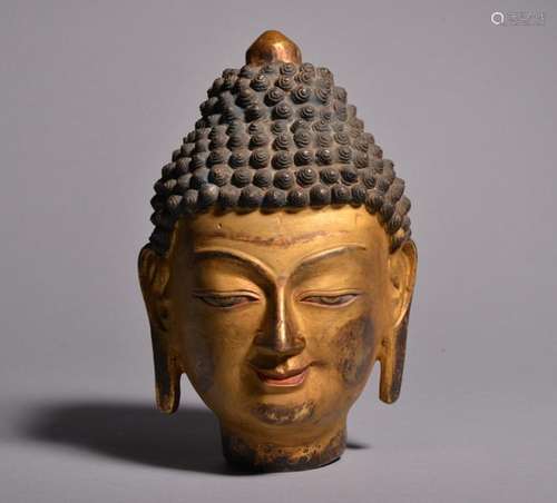 A GILT-BRONZE FIGURE OF BUDDHA'S HEAD. Ming Dynasty