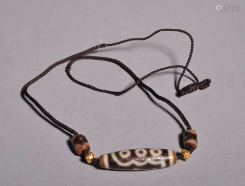 A TIBET GZI NECKLACE.