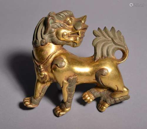 A GILT-BRONZE FIGURE OF LION. Qing Dynasty