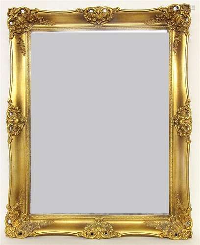 A BAROQUE STYLE WALL MIRROR Gilded wooden frame