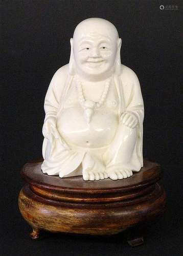 A SITTING LUCKY BUDDHA Fossil ivory carved, on