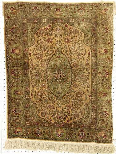 A FINE-KNOTTED SILK CARPET Greenish background