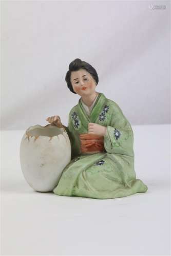 Groupe en biscuit polychrome figurant une femme japonaise en kimono retenant un oeuf.