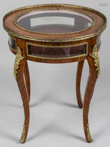 Circular glass inset top on gilt bronze