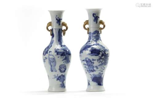 A matched pair of Chinese blue and white twin-handled slender vases