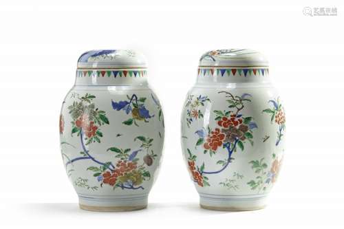 A pair of Chinese wucai 'floral' ovoid vases and covers