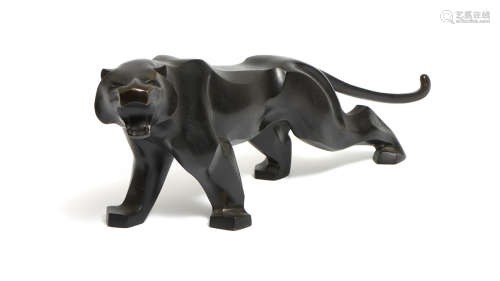 A stylised black patinated bronze roaring tiger figure