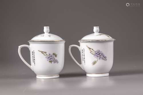 A pair of Chinese famille rose 'bird and wisteria' cups and covers