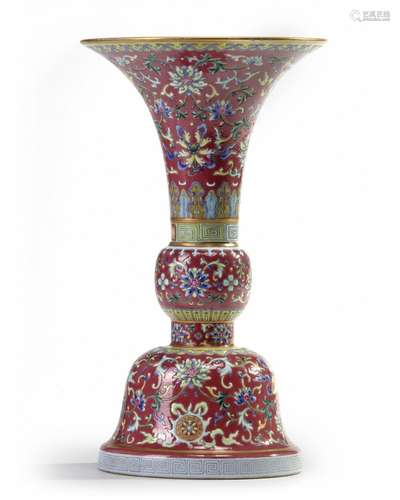 A Chinese ruby-ground famille rose 'bajixiang' gu vase