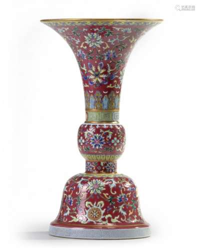 A Chinese ruby-ground famille rose 'bajixiang' gu vase
