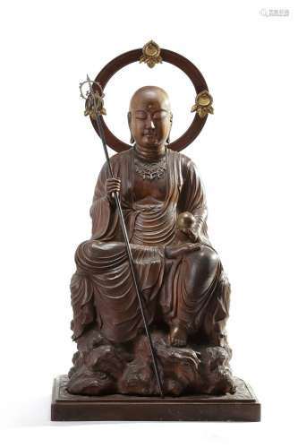 A wooden statue of a monk